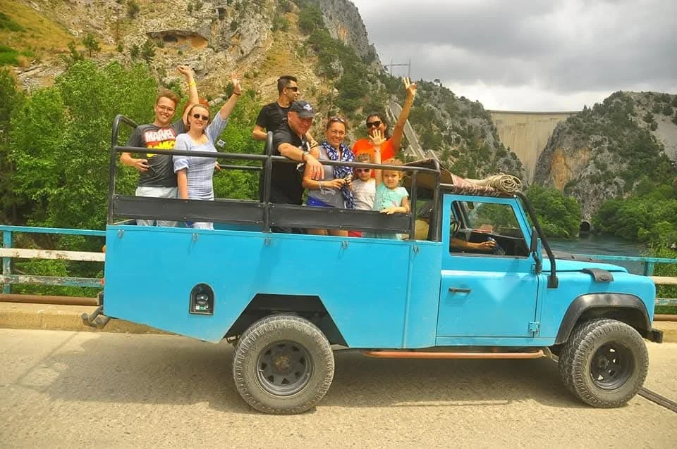 Jeep safari group on the mountain road above the canyon