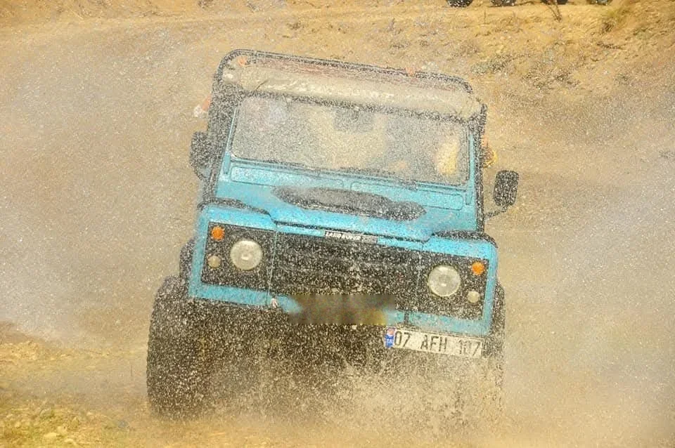 Open-top jeep crossing a stream on the Taurus mountain tracks