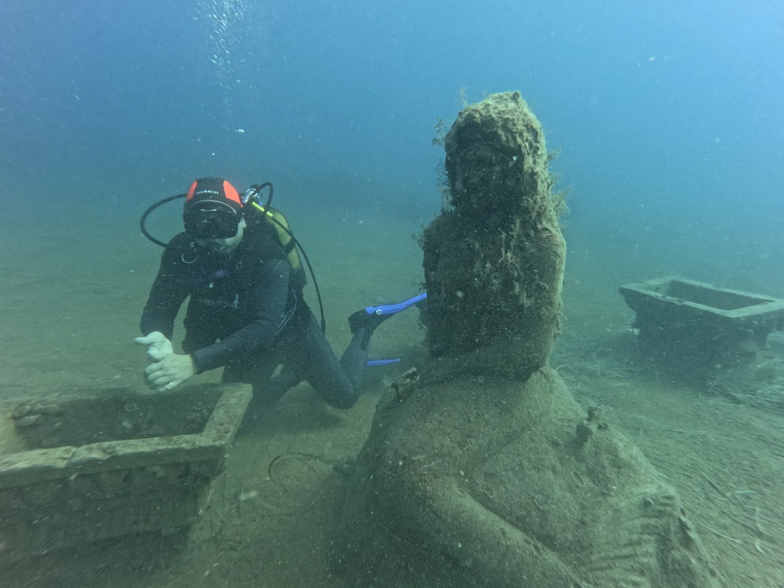diver beside statue museum side