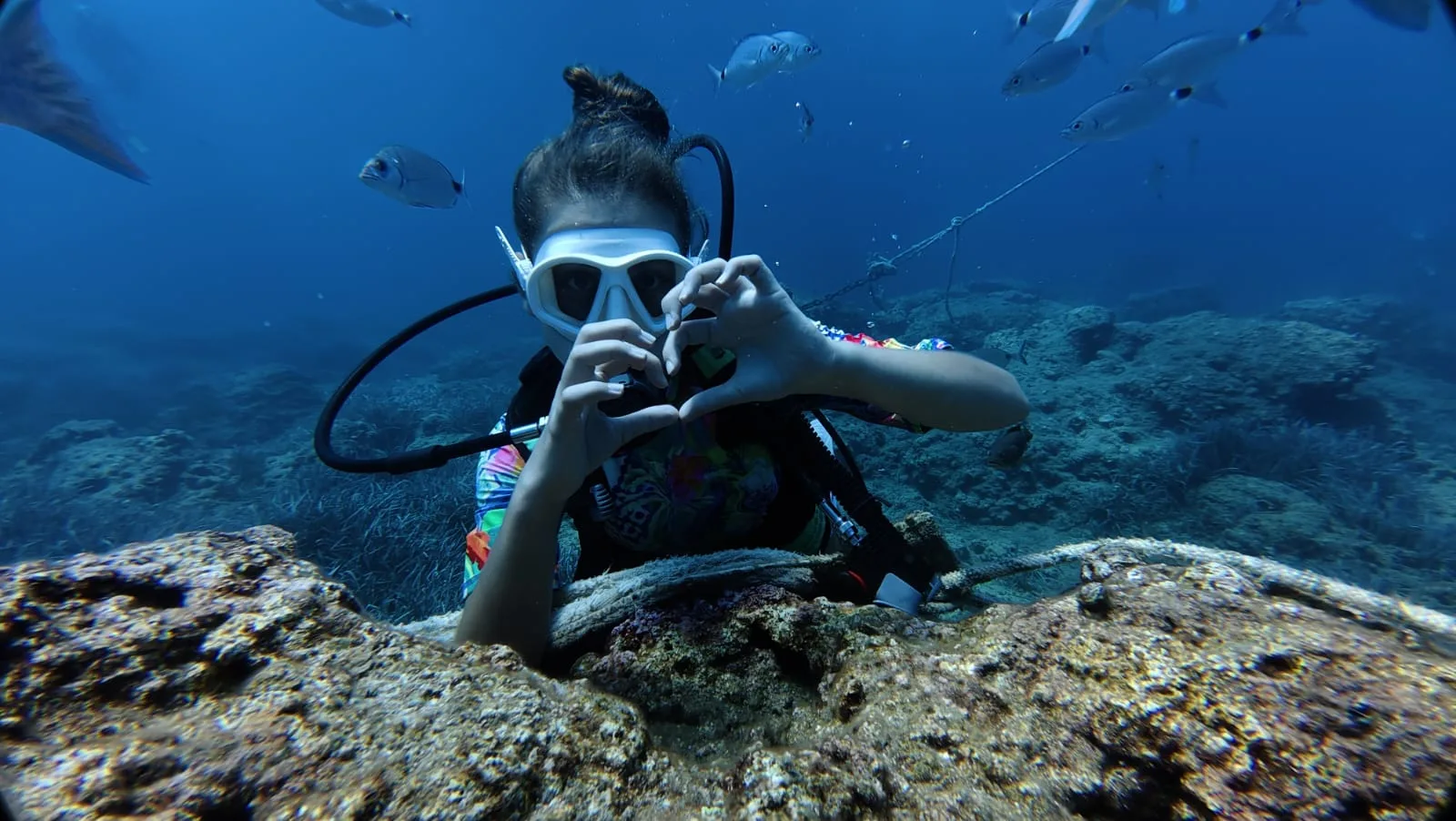 divers resting on reef side